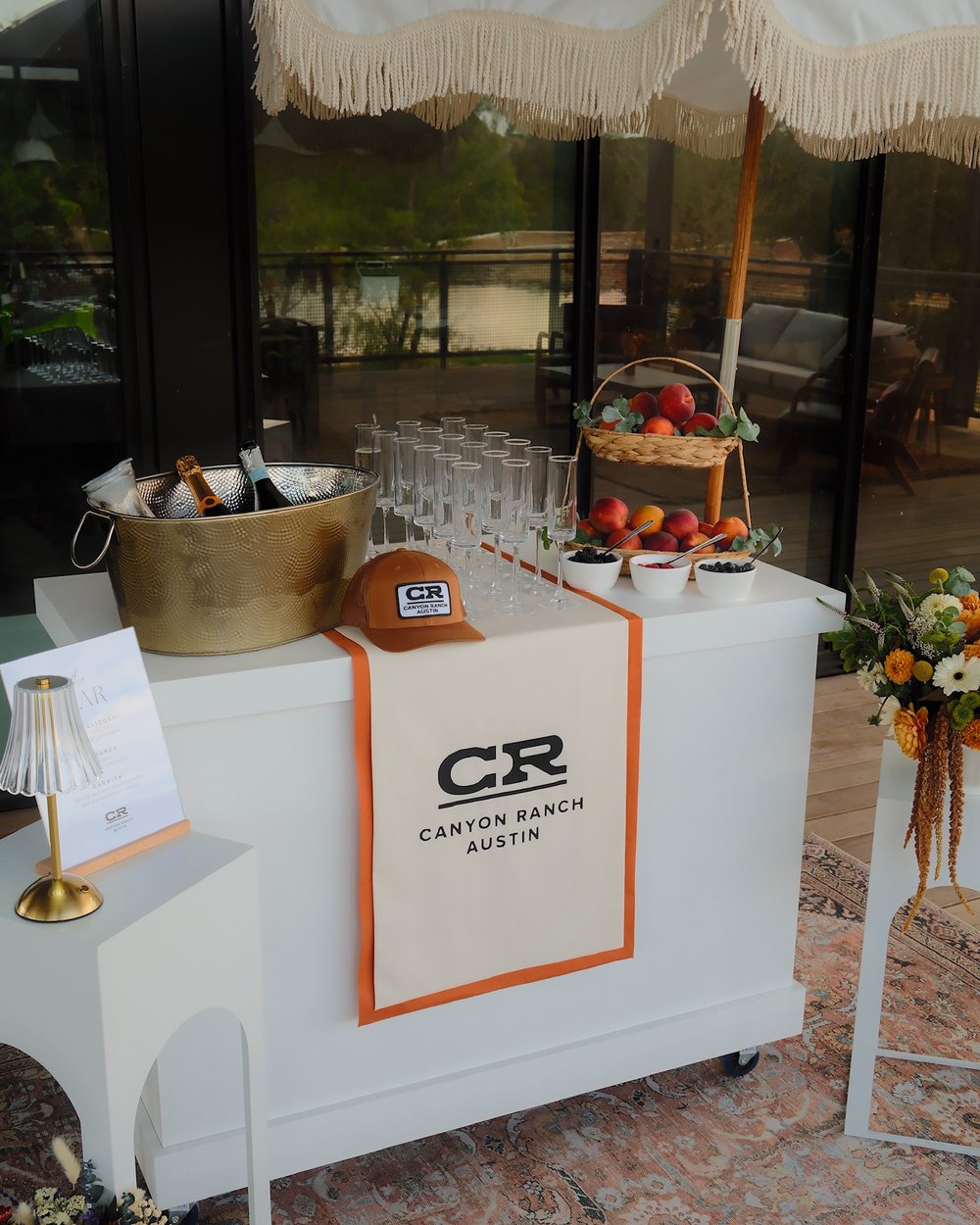 Canyon Ranch Austin branded champagne bar cart with flutes and fresh peaches
