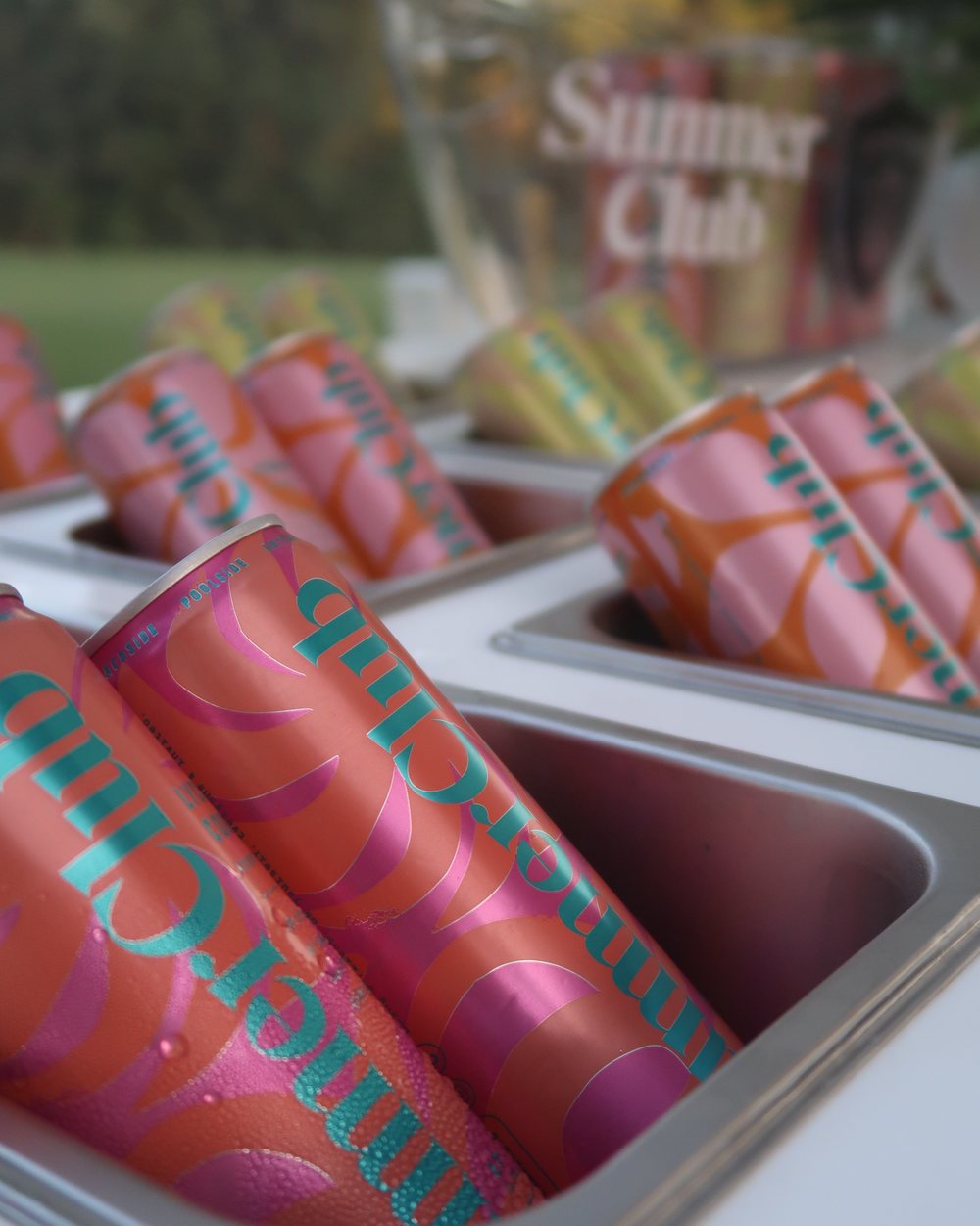 Close-up of Summer Club cans on the branded cart